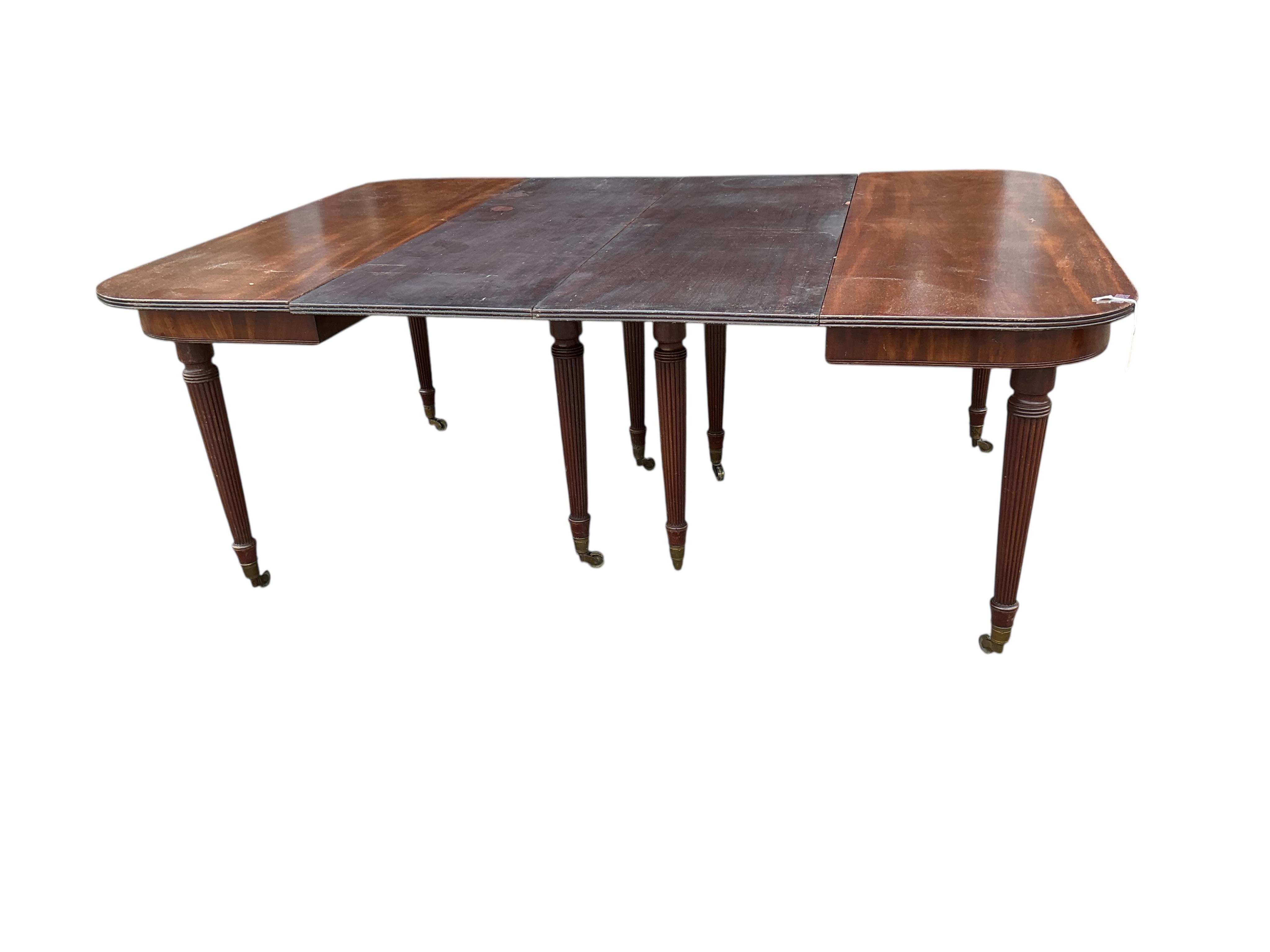 A Regency mahogany extending dining table, width 180cm extended, two spare leaves, depth 140cm, height 74cm